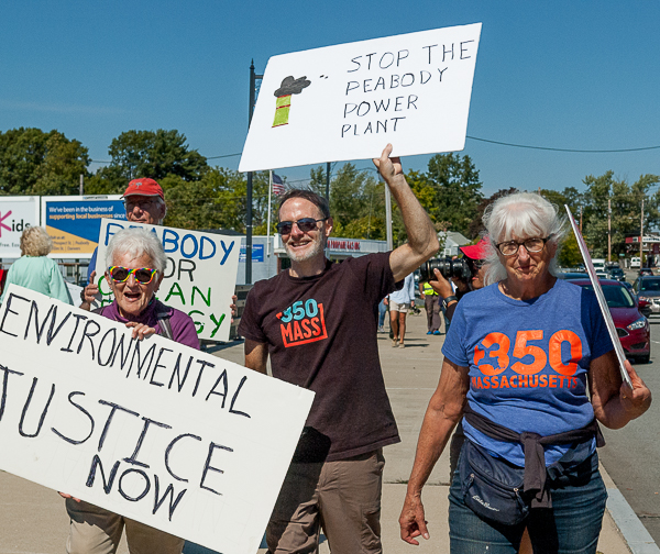 Pat Gozemba, Jim Mulloy, and Caroline Britt march towards scene of the "die-in."